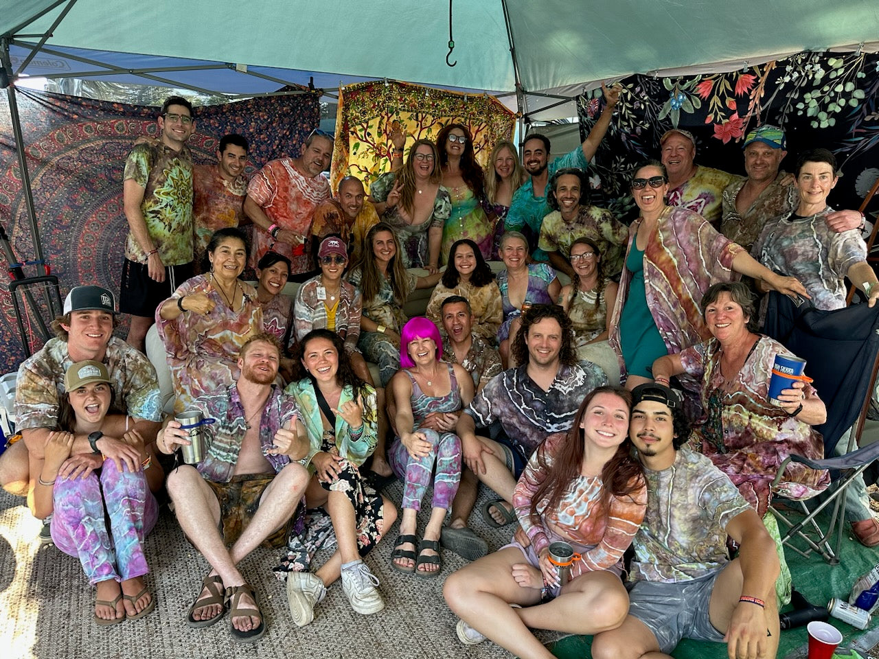 A large group of friends all wearing tie dye